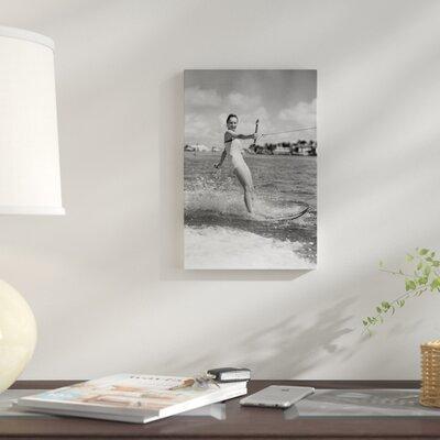 East Urban Home '1950s Smiling Woman in Bathing Suit Water Skiing Waving One Hand Looking at Camera' Photographic Print on Wrapped Canvas Canvas | Wayfair